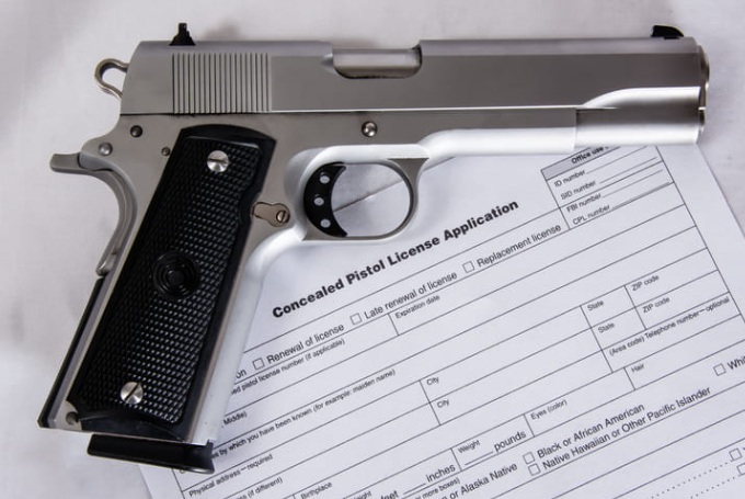 Photo of a Cocnealed Pistol License application with a handgun