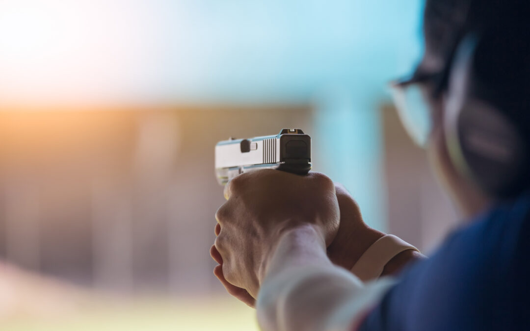A member of a gun range shoots a glock pistol