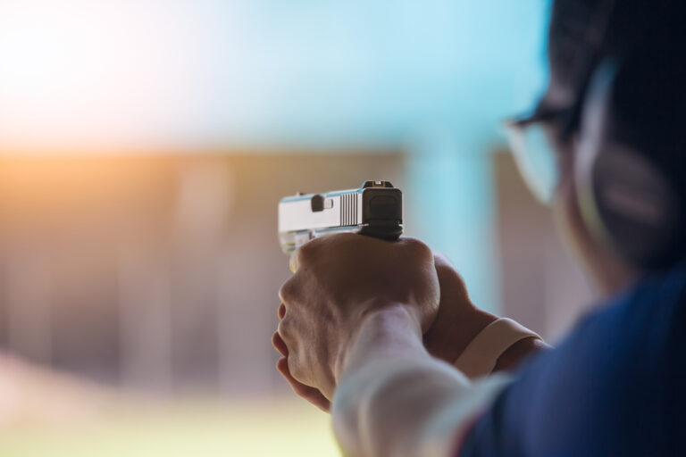 A member of a gun range shoots a glock pistol