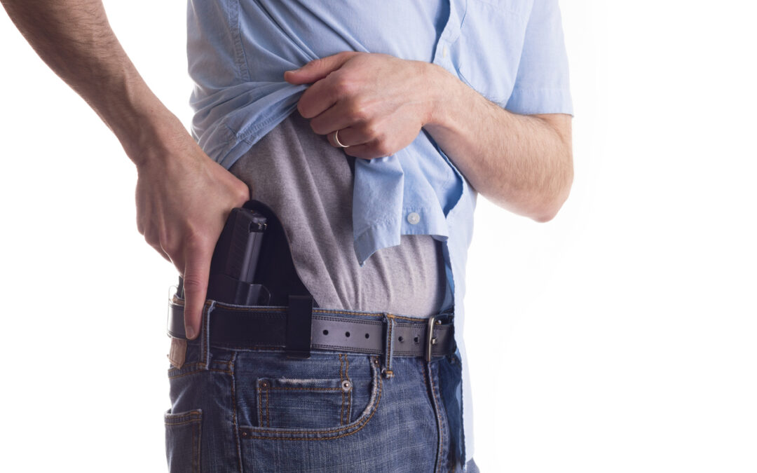 Michigan CPL holder demonstrating strong side IWB carry position and draw motion