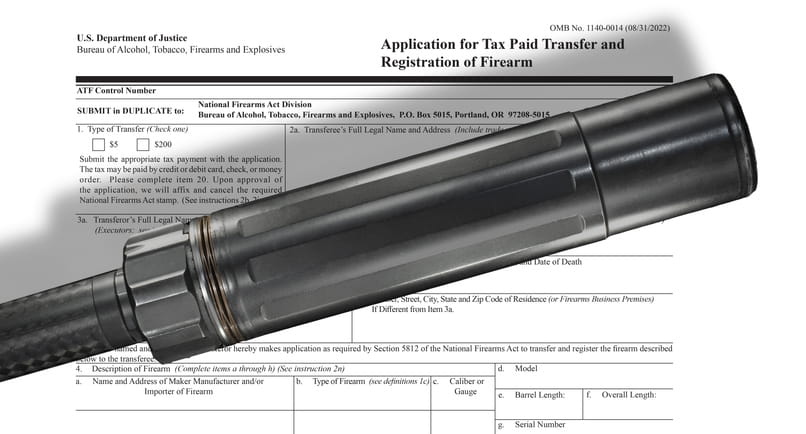 A close-up shot of a black metallic firearm suppressor placed diagonally over an official U.S. Department of Justice document. The paperwork is titled "Application for Tax Paid Transfer and Registration of Firearm" (ATF Form 4), highlighting the legal registration process for firearm accessories.